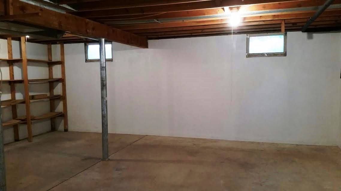 A living room with a fireplace and a ceiling fan