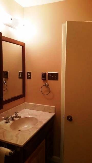 A kitchen with a lot of lights on the ceiling