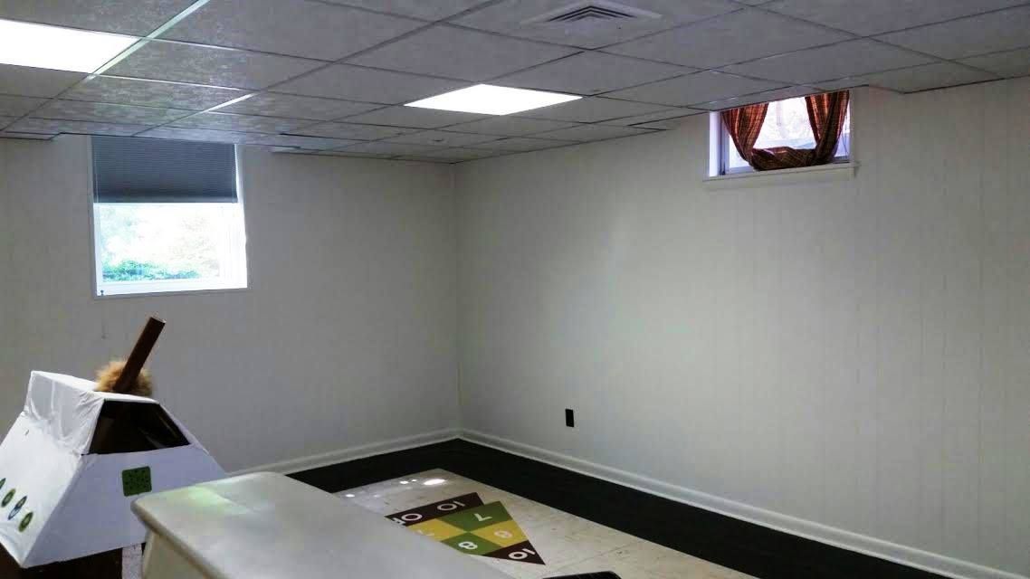 A living room with a couch , television and fireplace.