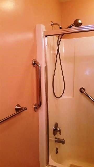 A basement with a staircase leading up to the second floor and a fireplace.