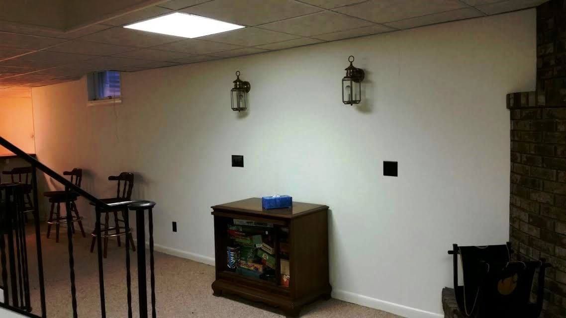 A bathroom with a shower , tub , and handrails.