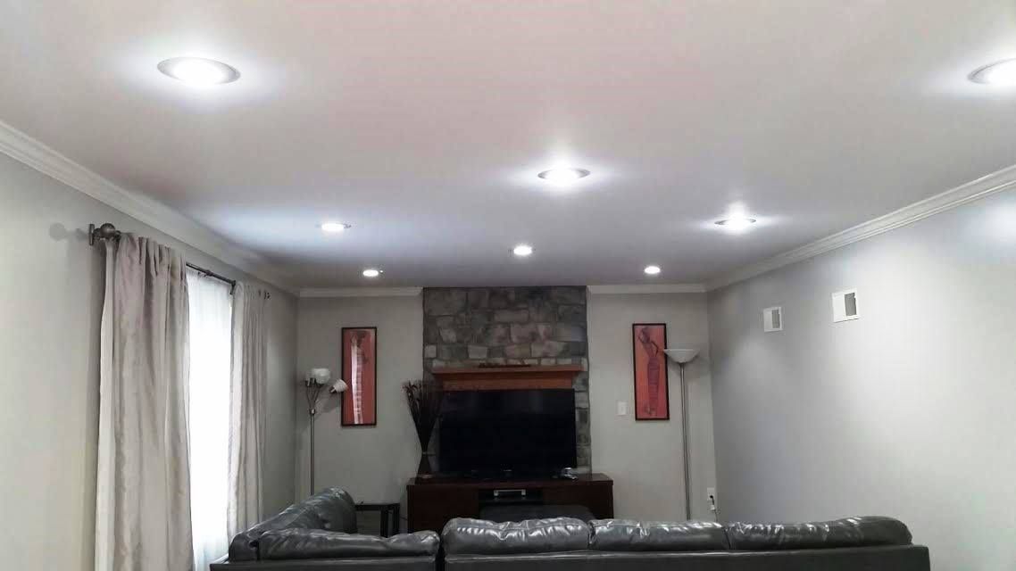 A living room with a couch , television and fireplace.