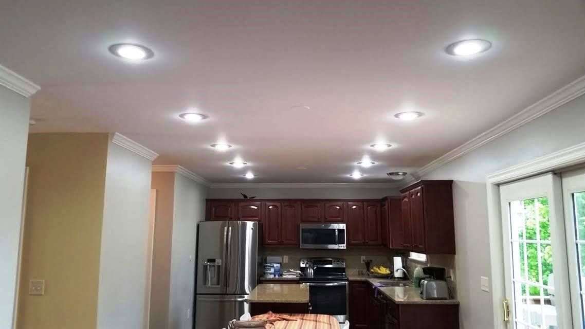 A kitchen with a lot of lights on the ceiling