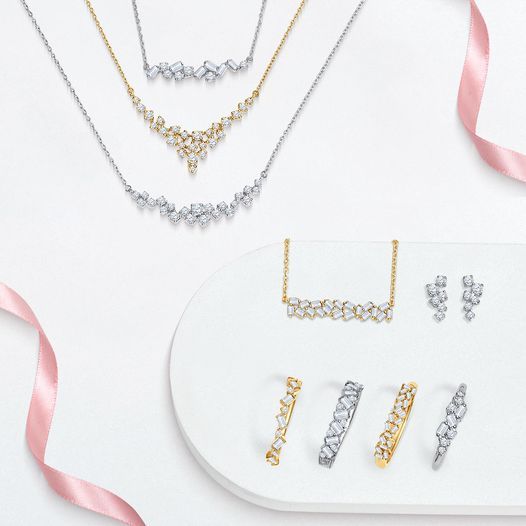 a variety of necklaces and earrings are on a white plate with a pink ribbon .