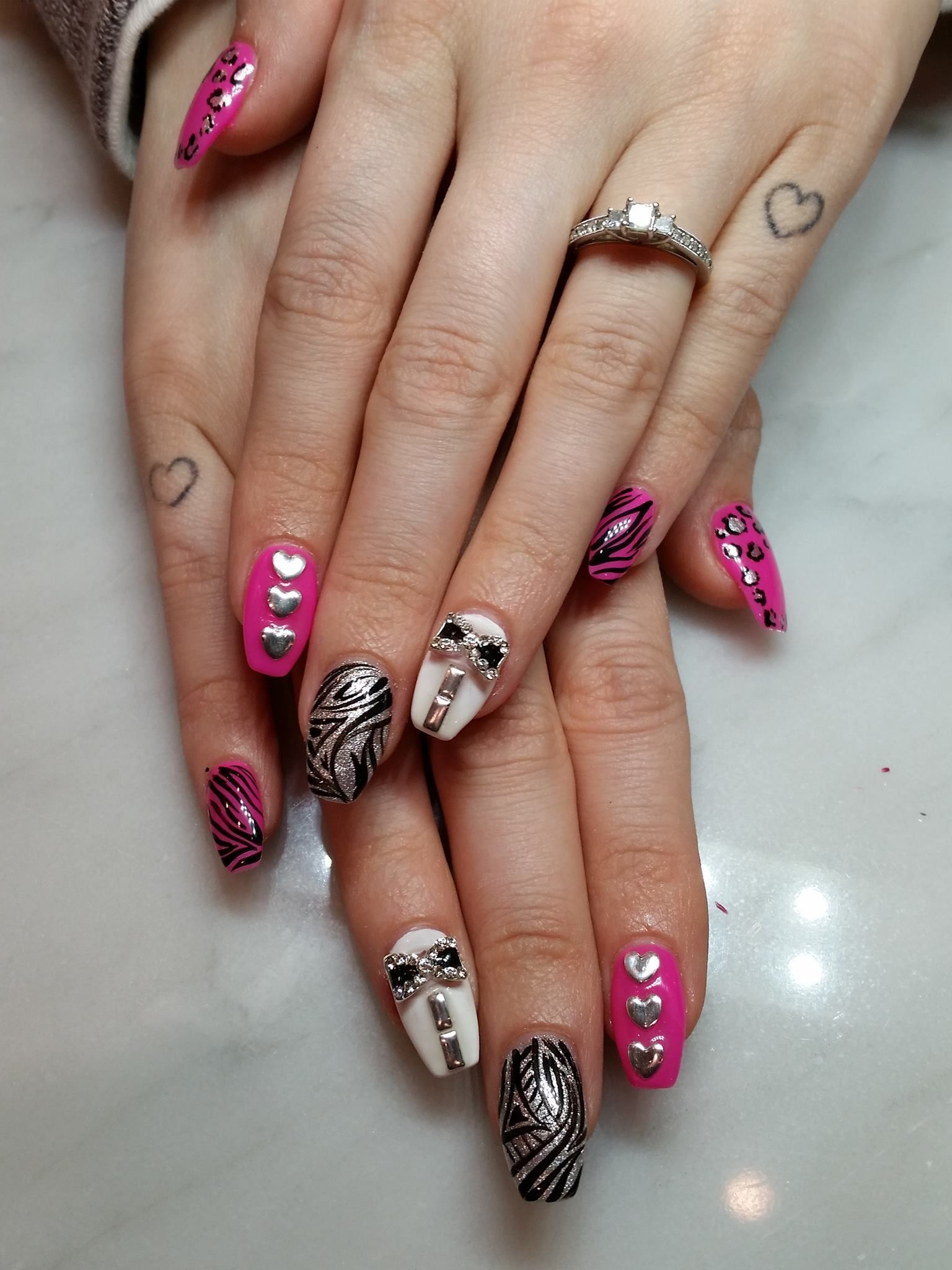 A close up of a woman 's nails with a ring on her finger.