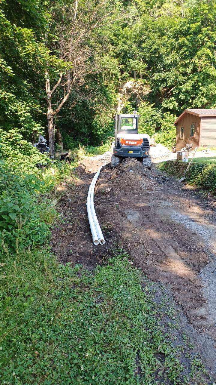 A bulldozer is driving down a dirt road.