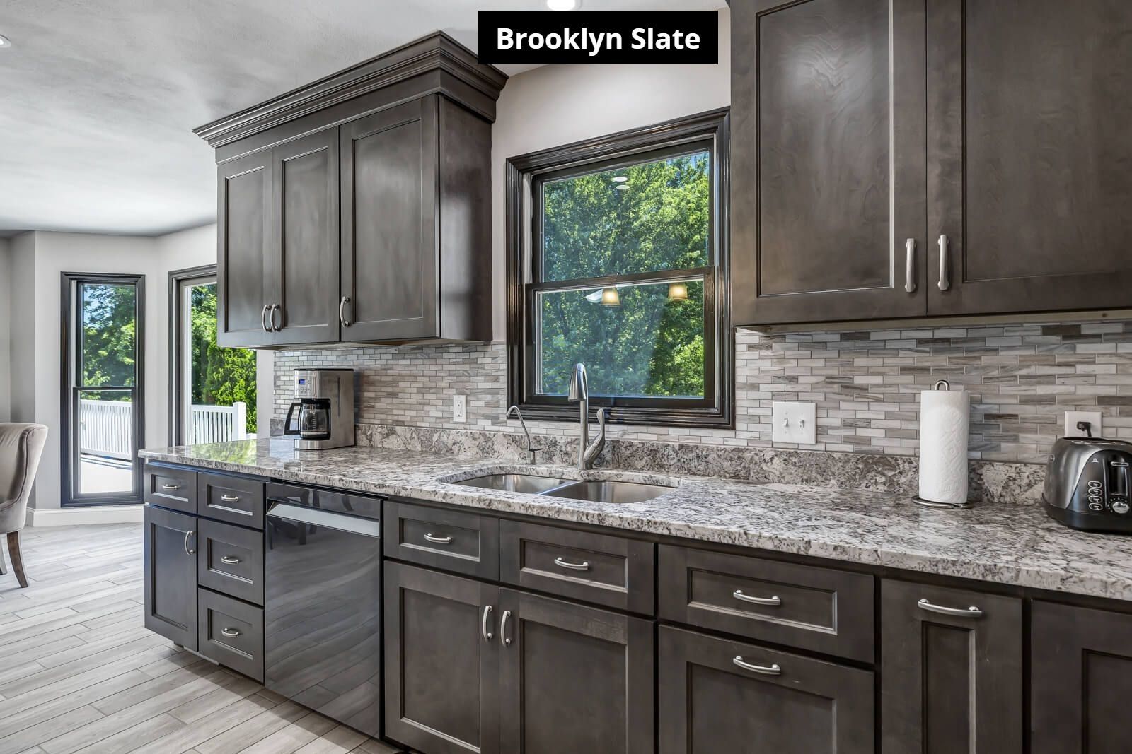A kitchen with stainless steel appliances and granite counter tops.