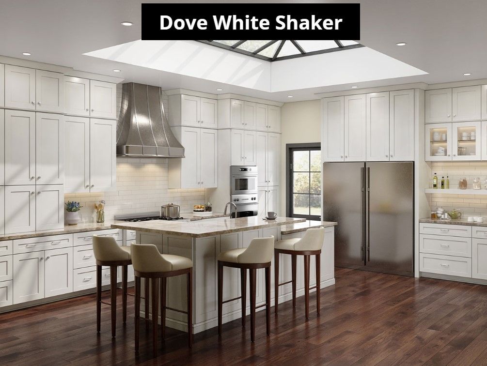 A kitchen with white cabinets , stainless steel appliances and a skylight.