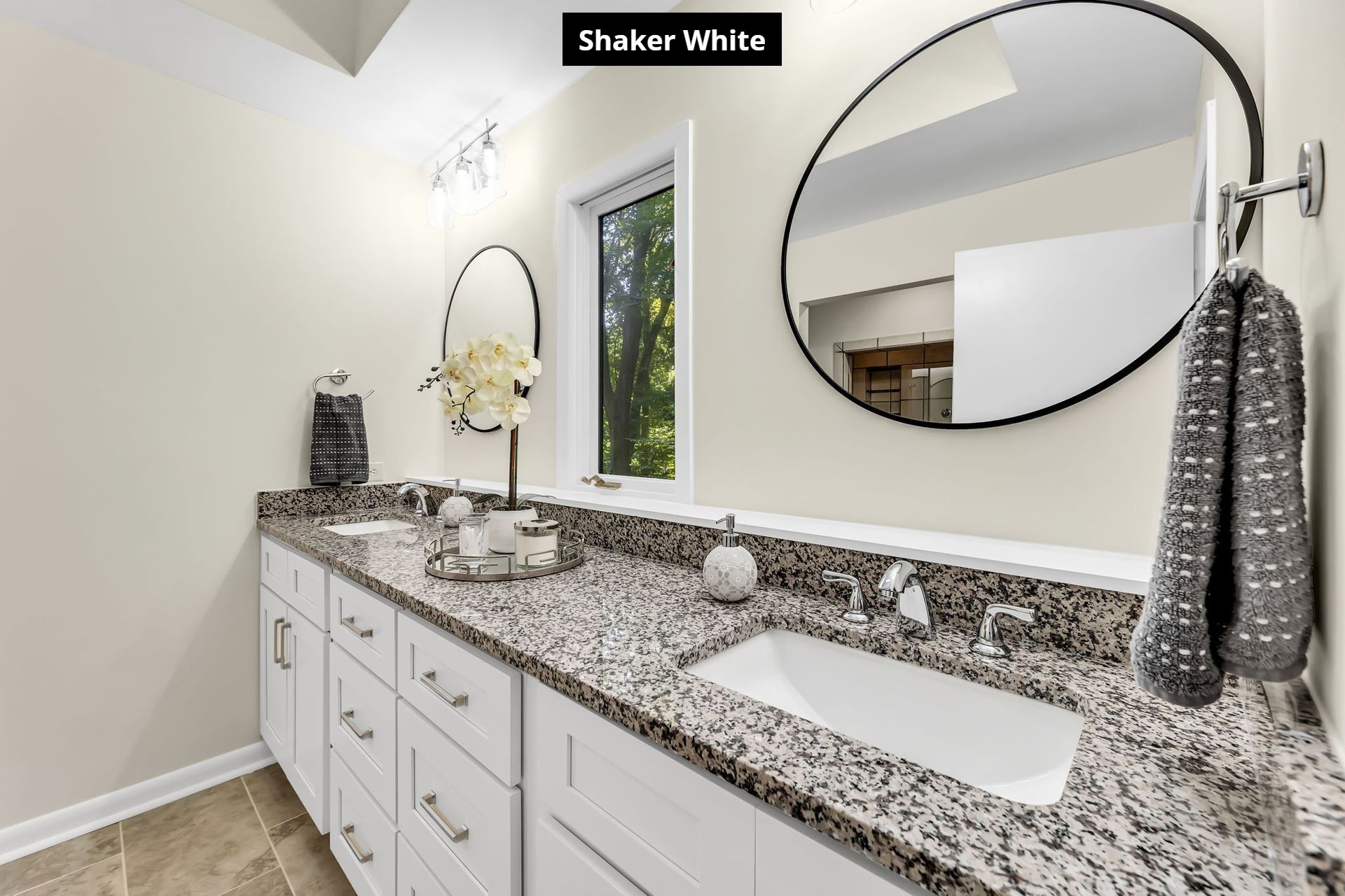 A bathroom with two sinks and a large mirror.
