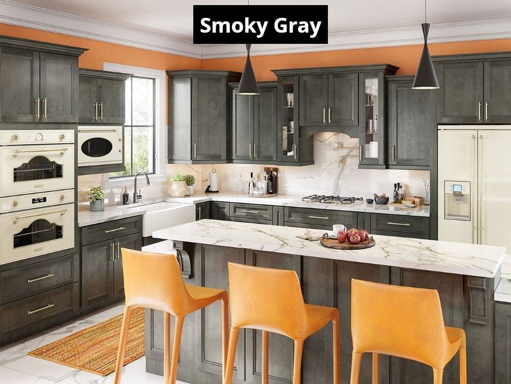 A kitchen with gray cabinets and orange chairs and a large island.
