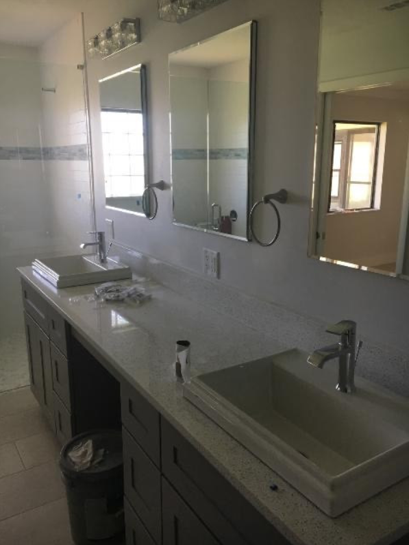 A bathroom with two sinks and two mirrors.