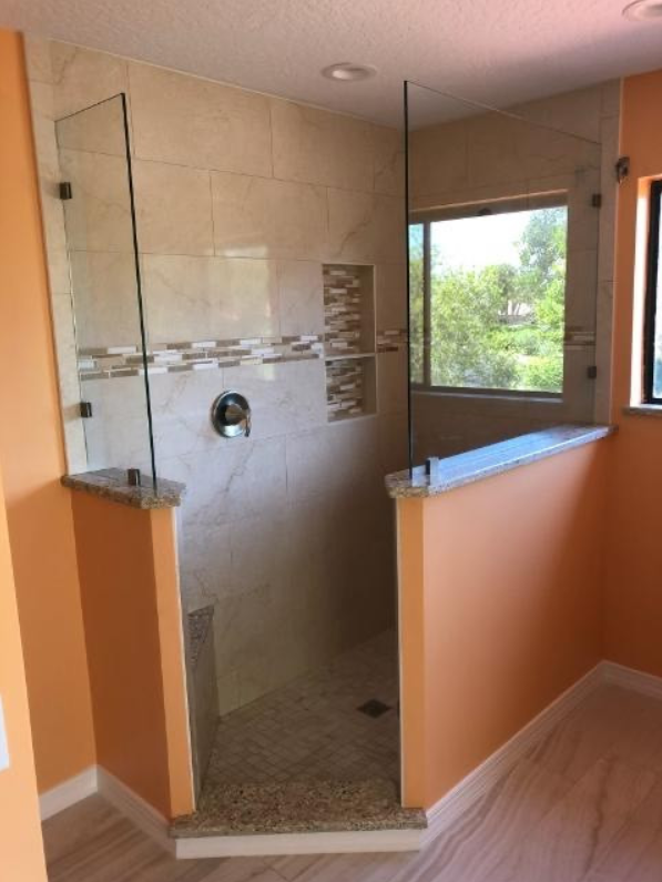 A bathroom with a walk in shower and a window