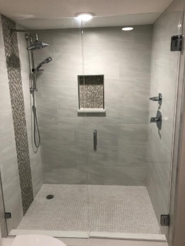 A bathroom with a walk in shower and a toilet.
