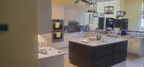 A kitchen with a large island in the middle of it.