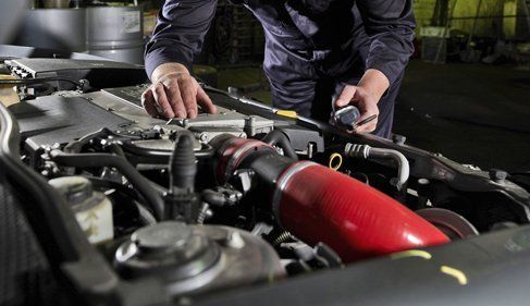 Learn More About Tune-Ups man working on an engine