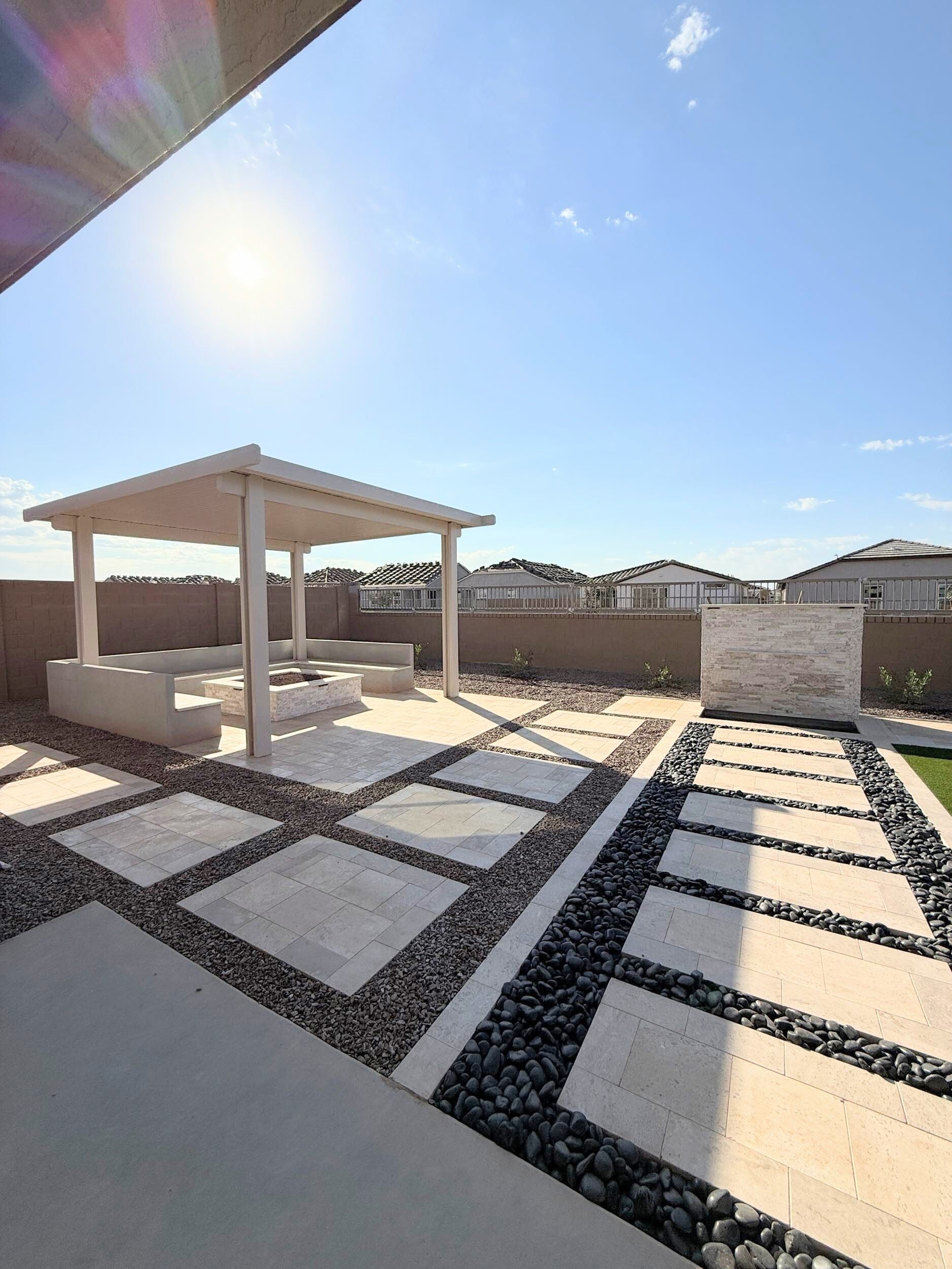 There is a gazebo in the middle of the backyard.
