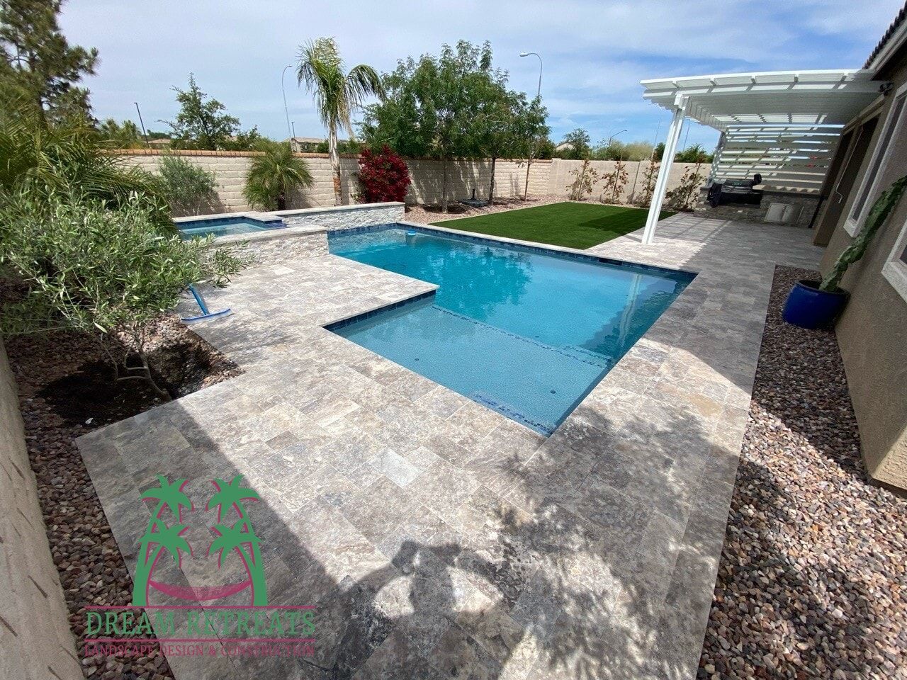 There is a large swimming pool in the backyard of a house.