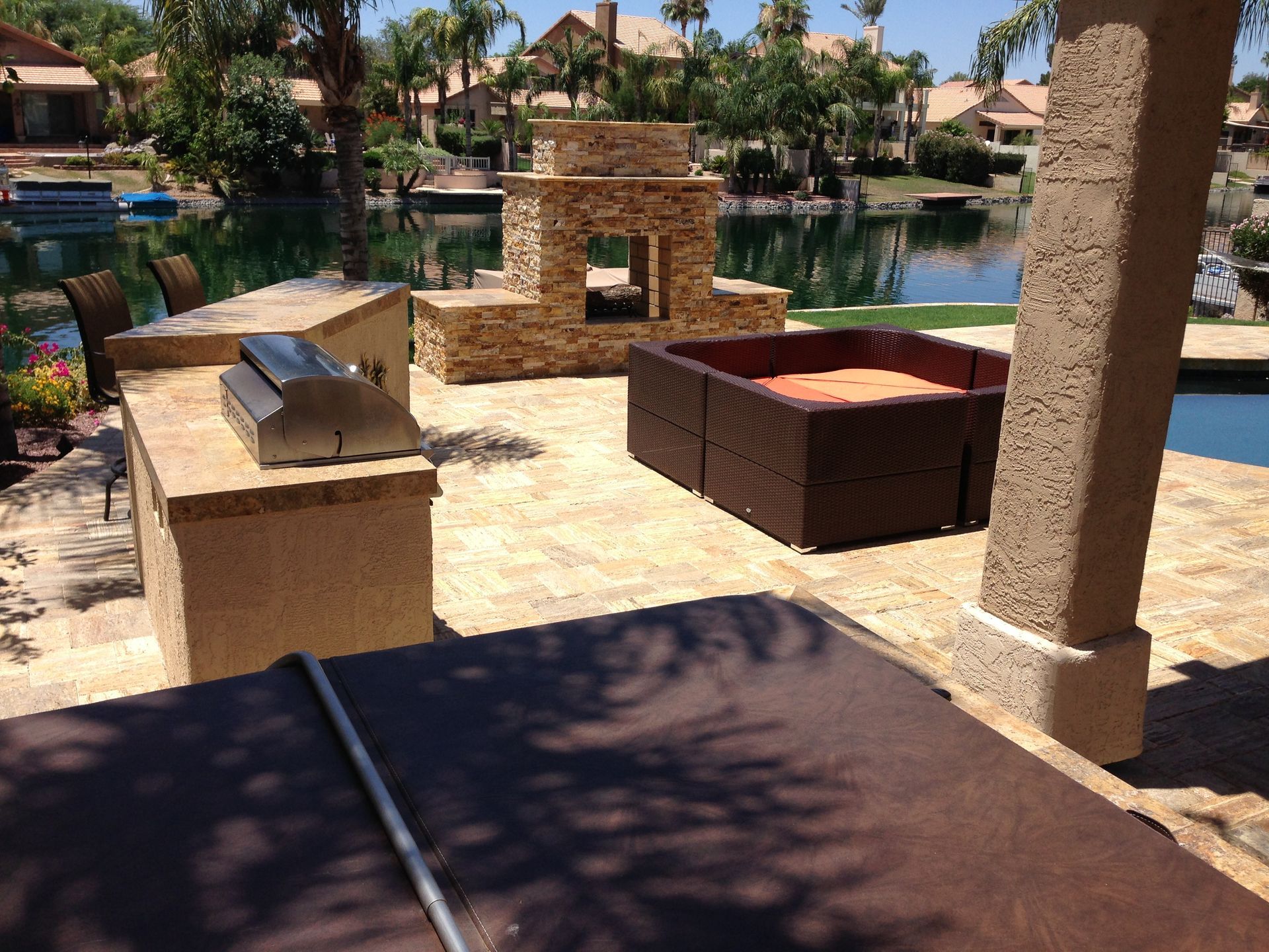 A patio area with a fireplace and a pool