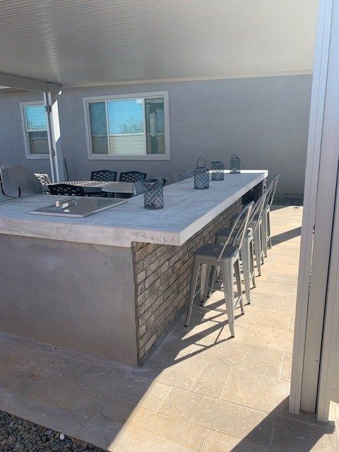 A kitchen with a large counter top and stools