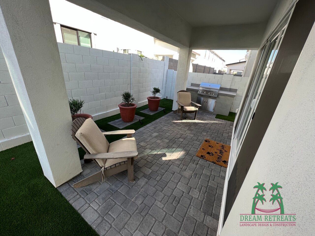 A patio with chairs and a sign that says dreams retreats