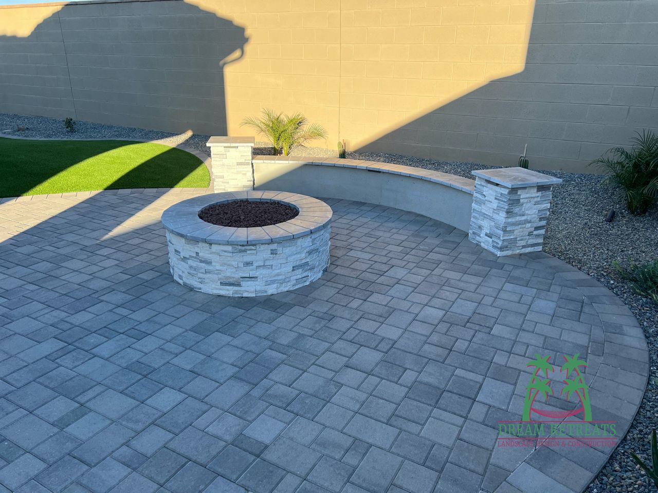 A fire pit is sitting on top of a brick patio.