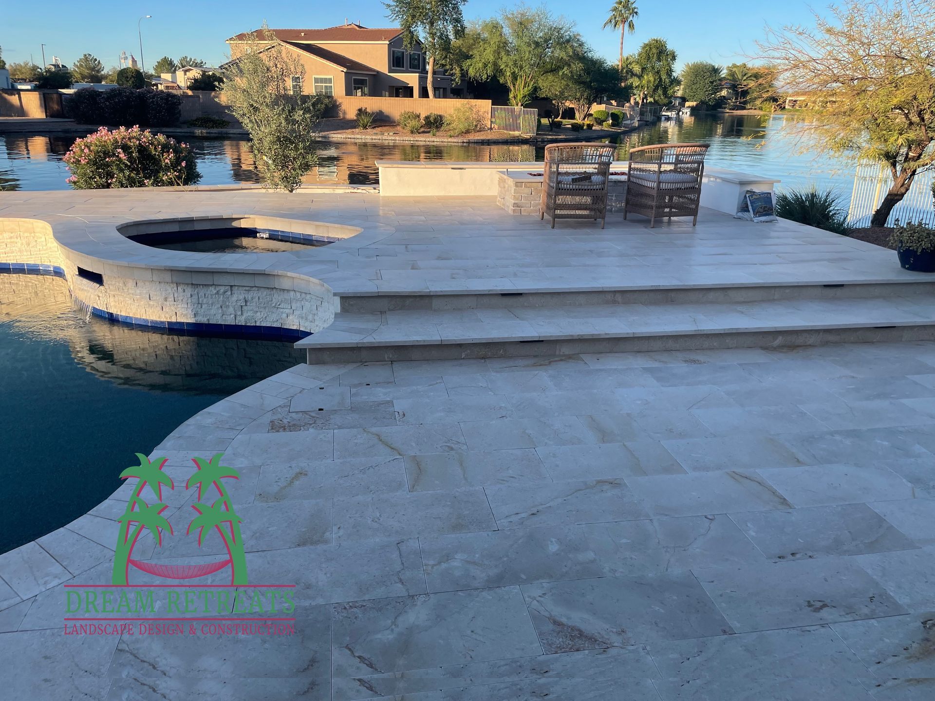 A patio with a swimming pool in the background