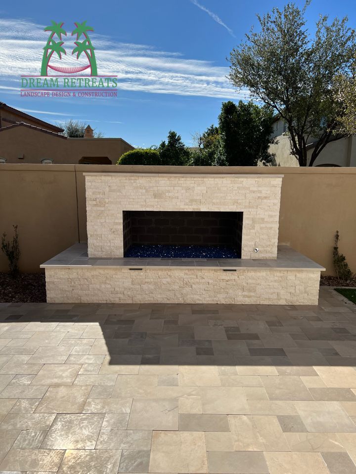 There is a fireplace in the backyard of a house.
