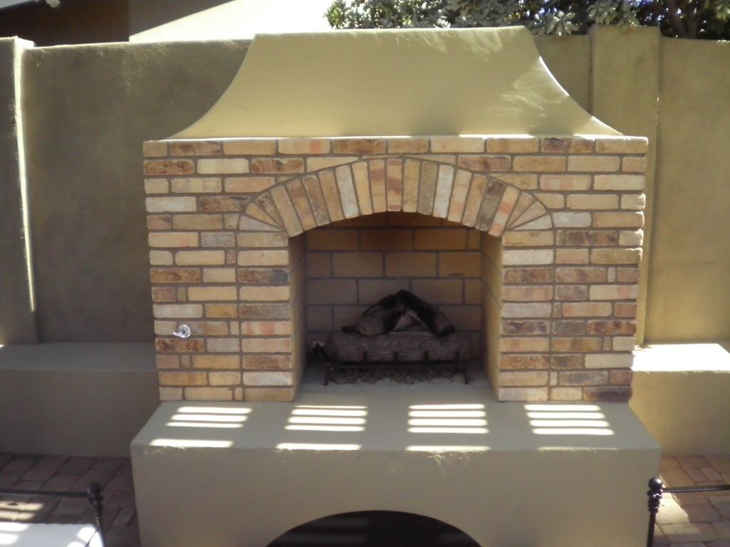 A brick fireplace with a chimney on top of it