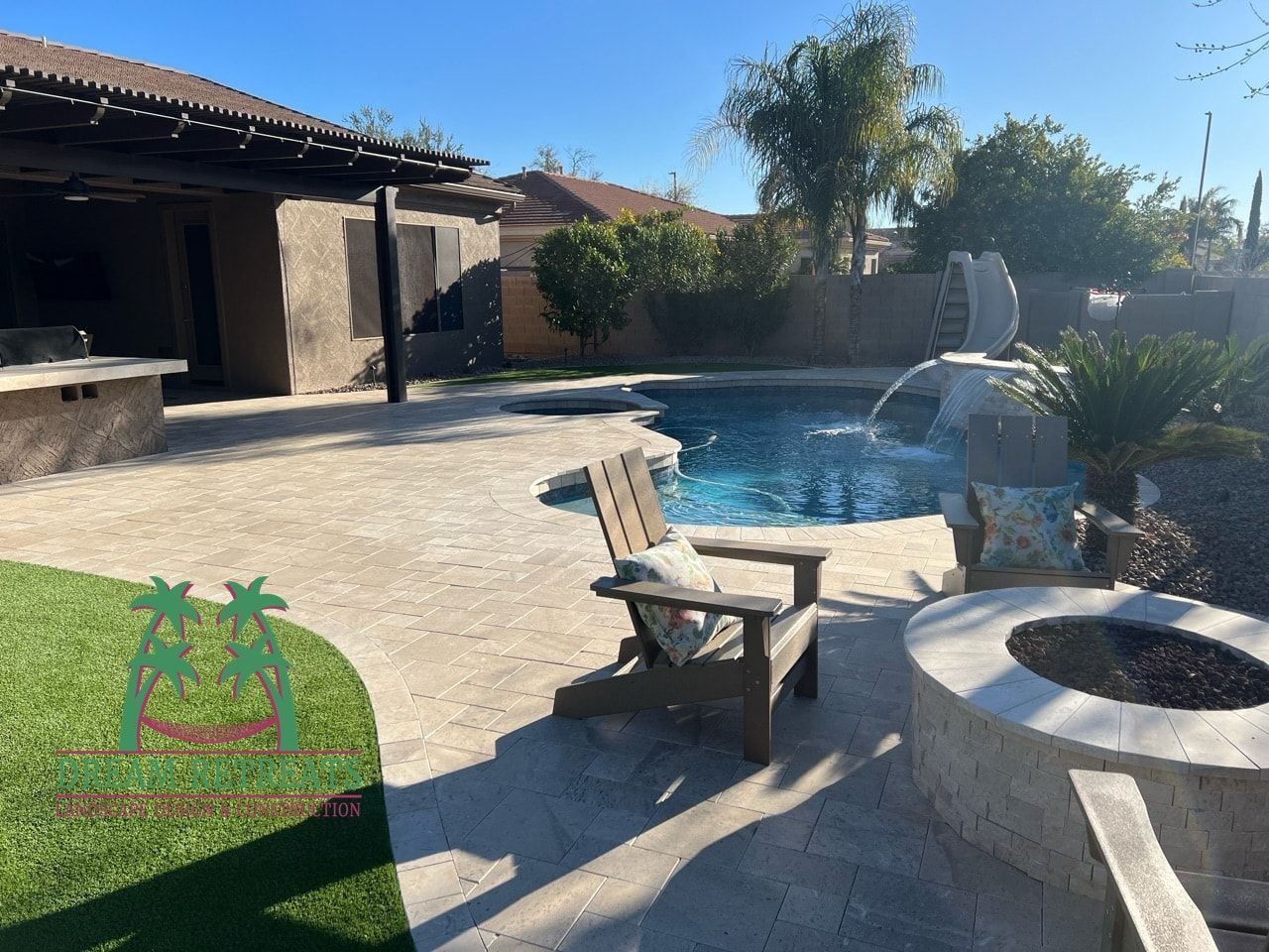 A backyard with a swimming pool and a fire pit