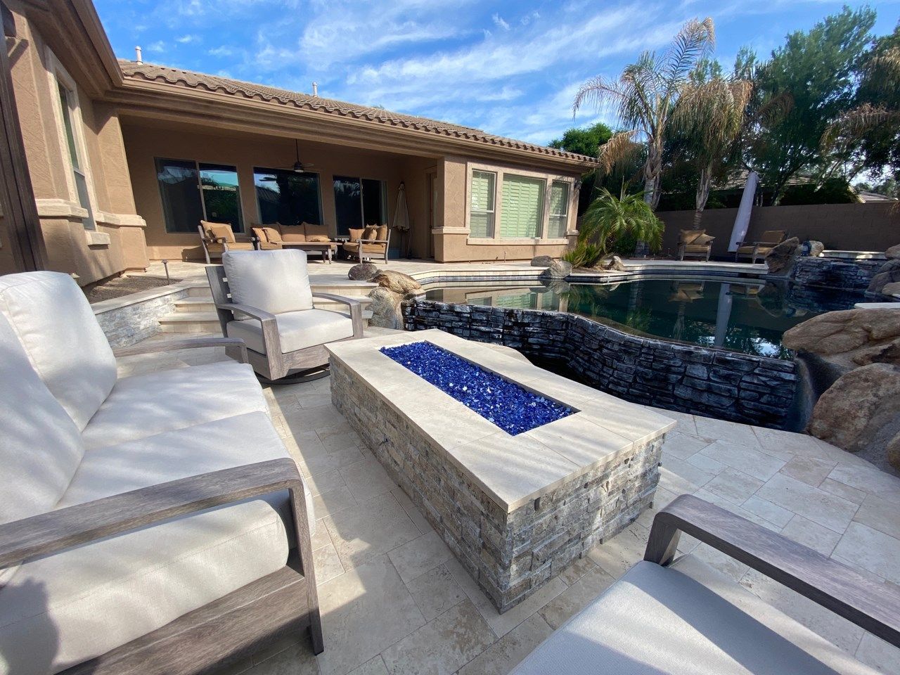 There is a fire pit in the backyard of a house.