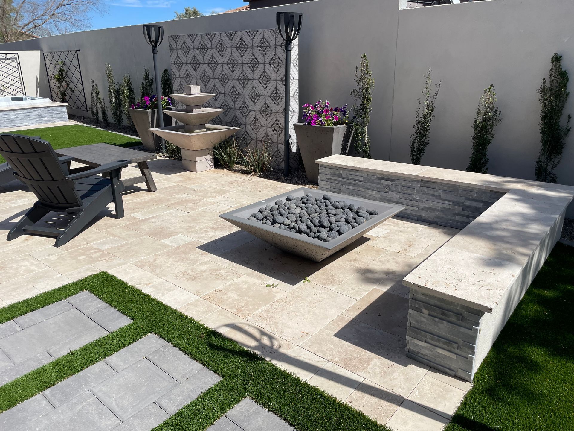 There is a fire pit in the middle of the patio.