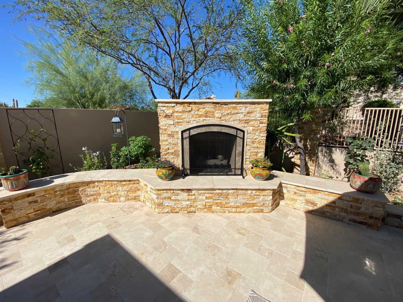 There is a fireplace in the middle of the patio.