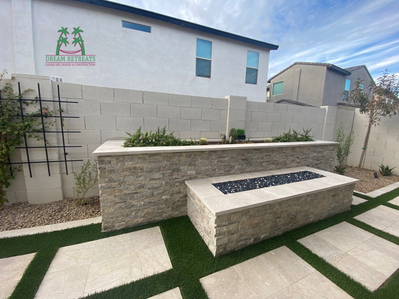 There is a fire pit in the backyard of a house.