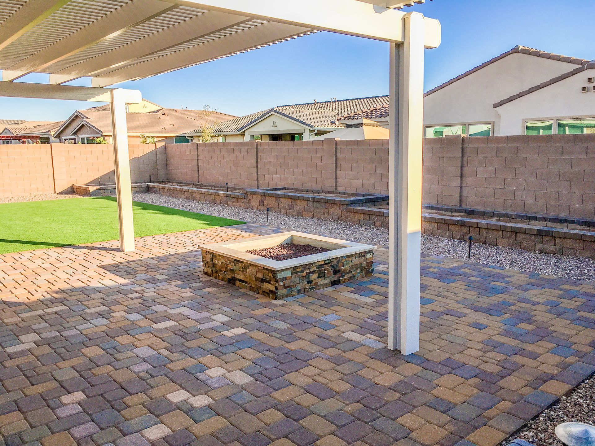 There is a fire pit in the middle of the patio.