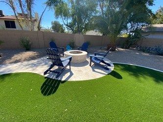 There is a fire pit in the middle of the backyard.