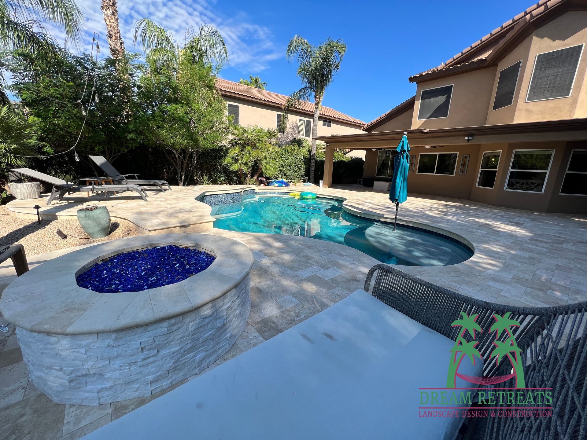 A large house with a swimming pool and a fire pit