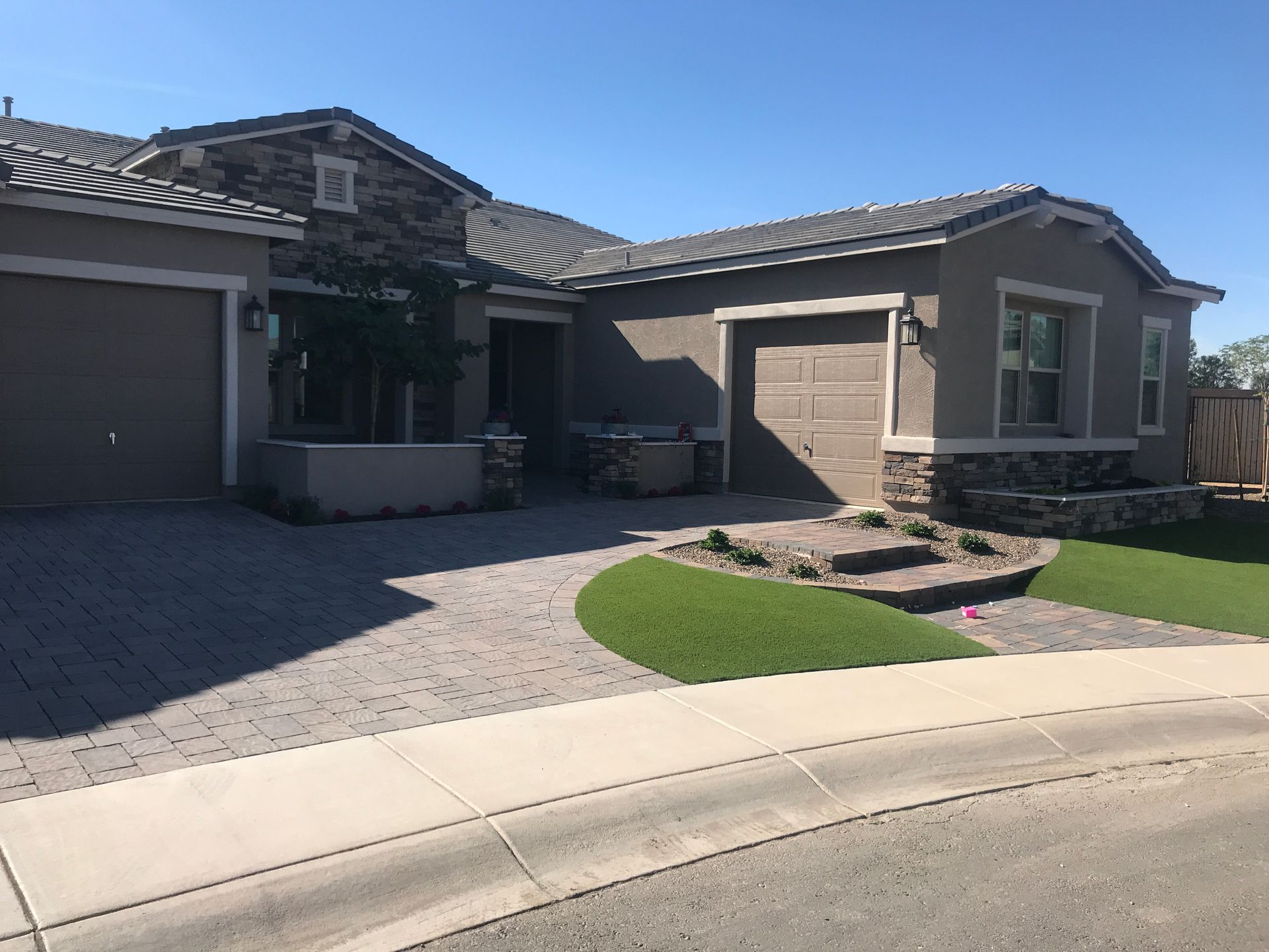 A large house with a lot of windows and a driveway