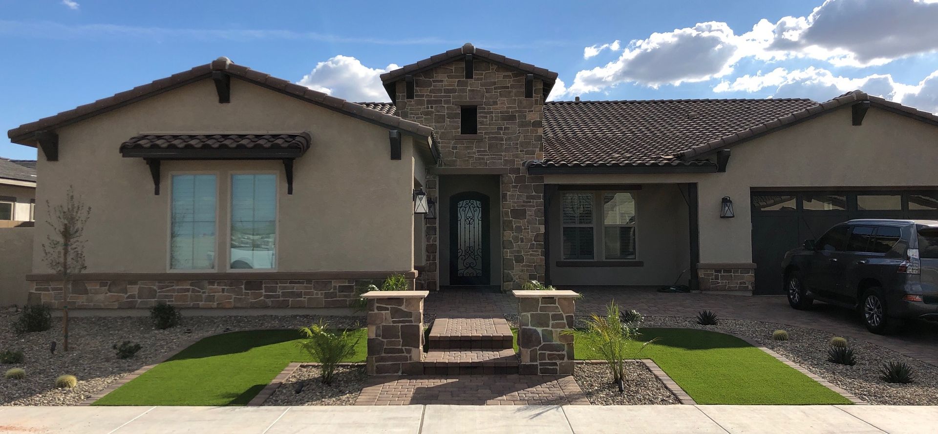 A large house with a car parked in front of it.