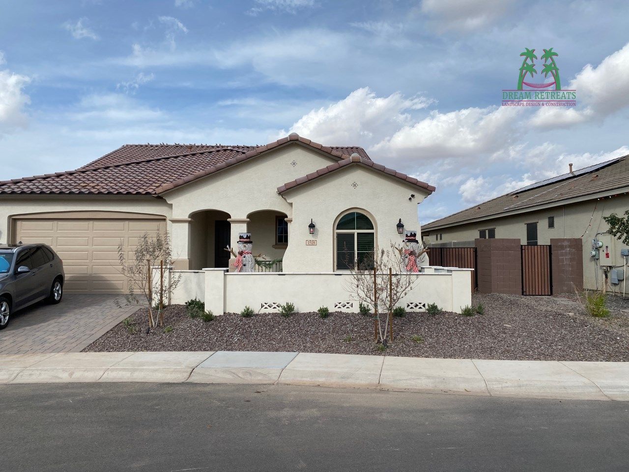 A white house with a car parked in front of it