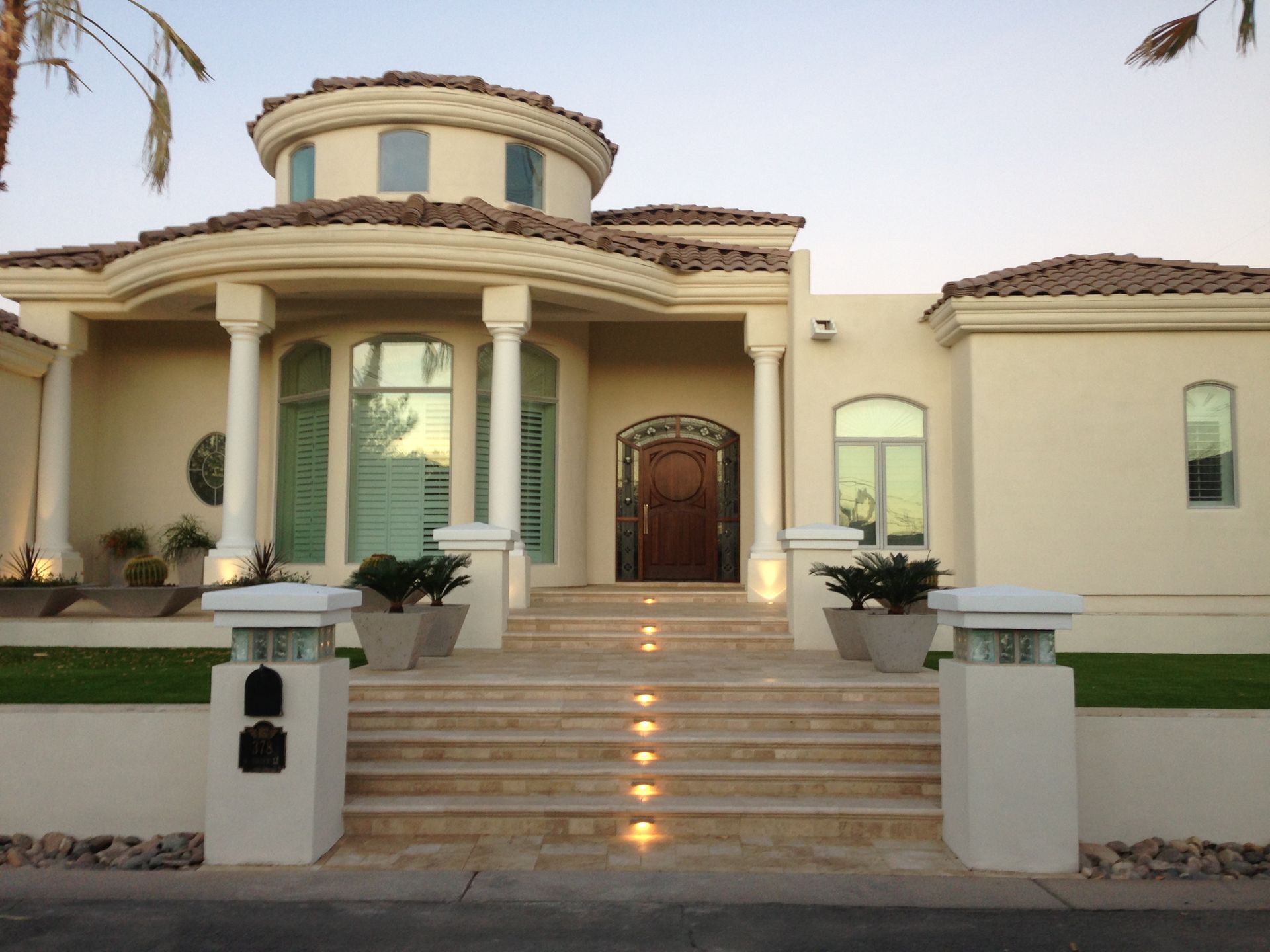 A large white house with stairs leading up to it