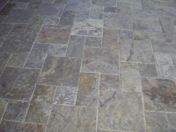 A close up of a tiled floor with a geometric pattern