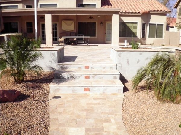 A house with a patio and stairs leading up to it