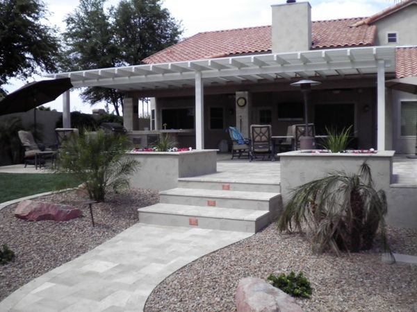 A house with a pergola and stairs leading up to it