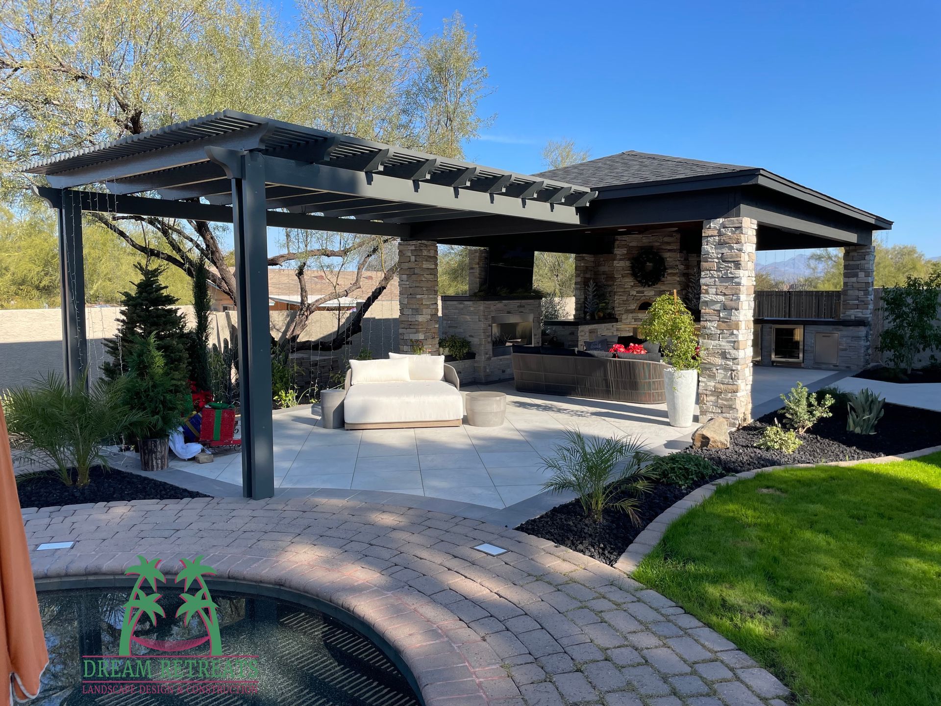 A pergola is sitting next to a pool in a backyard.