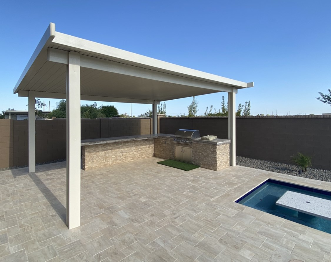 A patio with a pergola and a swimming pool