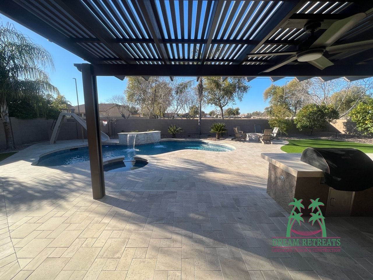 A patio with a pergola over it and a swimming pool