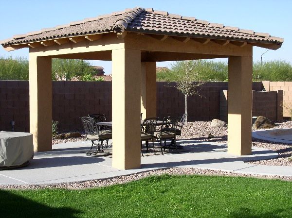 A gazebo with a table and chairs underneath it