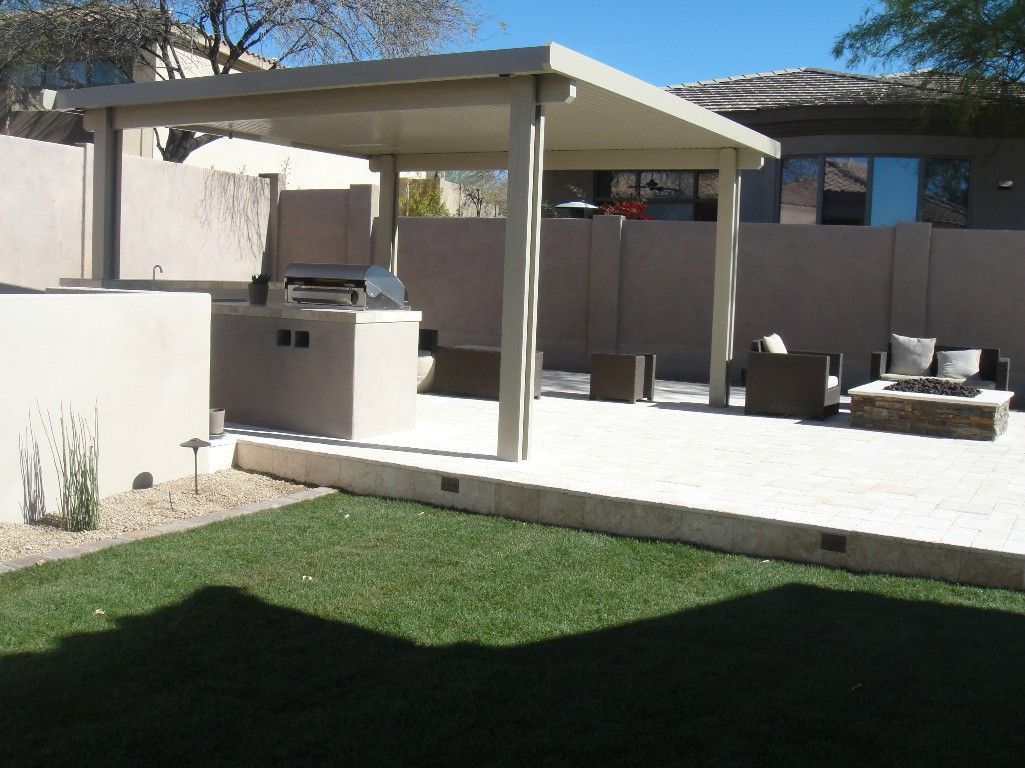 A patio with a covered area and a fire pit
