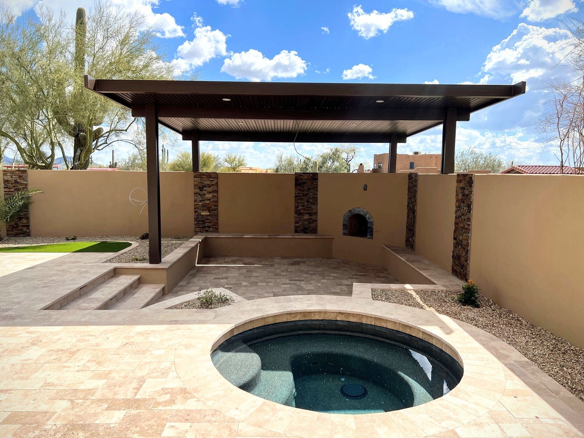 There is a hot tub in the middle of the patio.