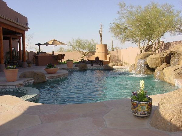 A large swimming pool with a fountain in the middle